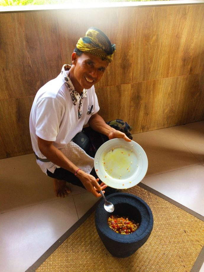 Our Friendly Chef showing us how to use the Balinese Pestle and Mortar